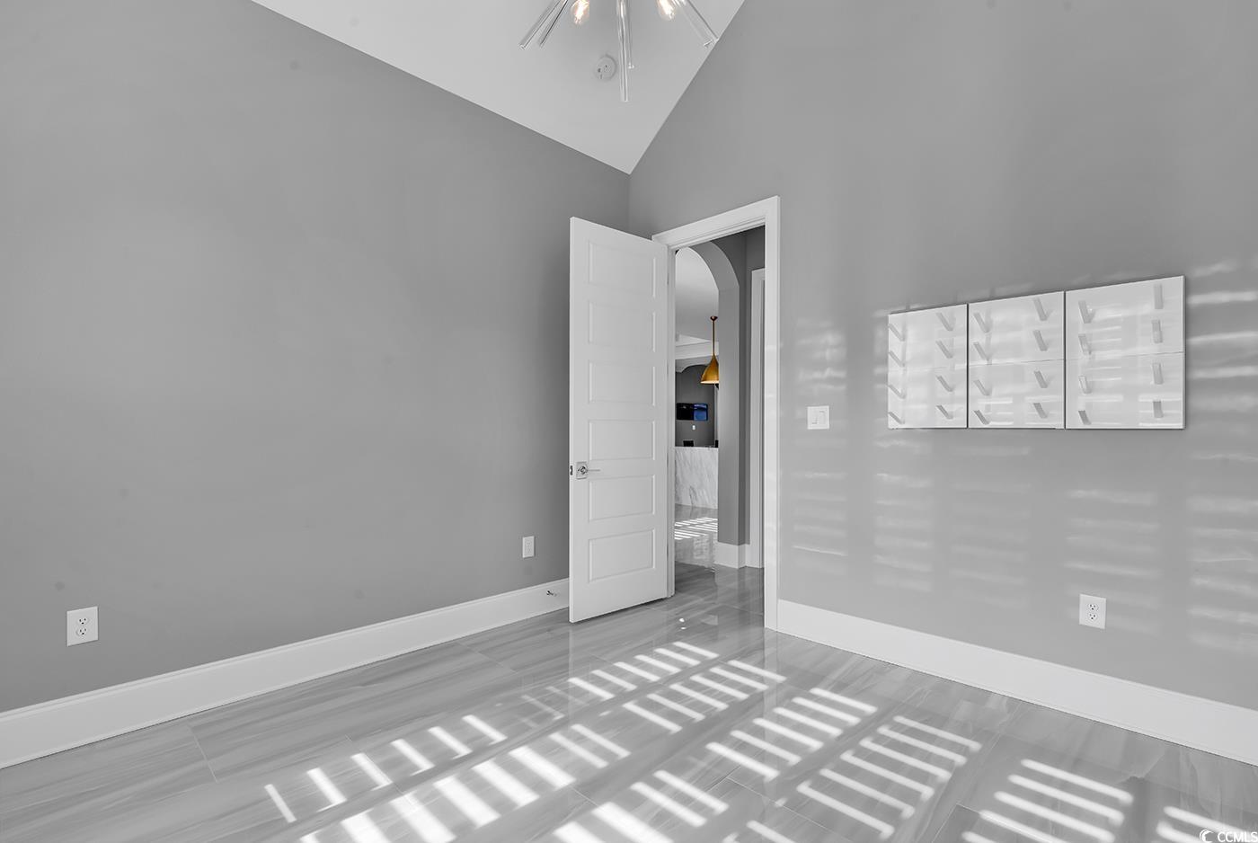 5960 Bolsena Place Myrtle Beach, SC 29572 - Photo 19 of 40 Spare room featuring high vaulted ceiling