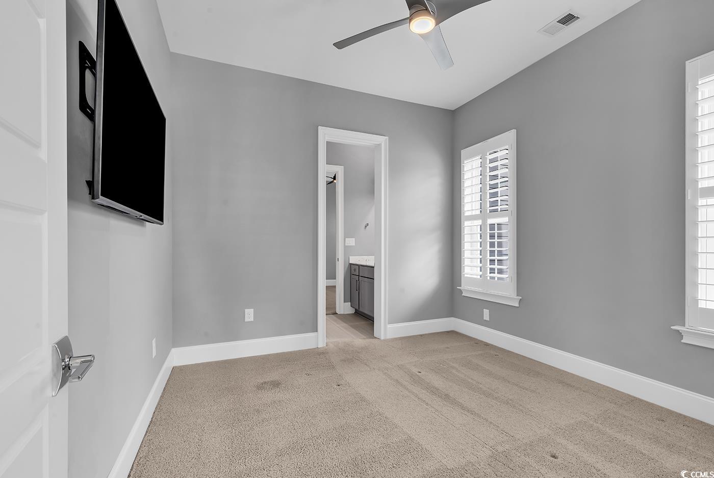 5960 Bolsena Place Myrtle Beach, SC 29572 - Photo 20 of 40 Unfurnished bedroom with ceiling fan, light colored carpet, and ensuite bathroom