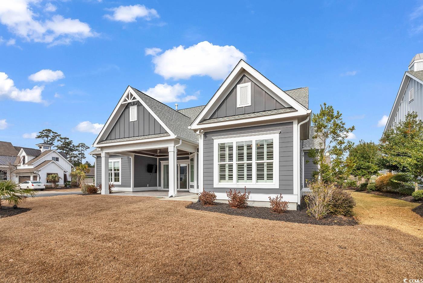 5960 Bolsena Place Myrtle Beach, SC 29572 - Photo 2 of 40 Back of house featuring a patio and a yard