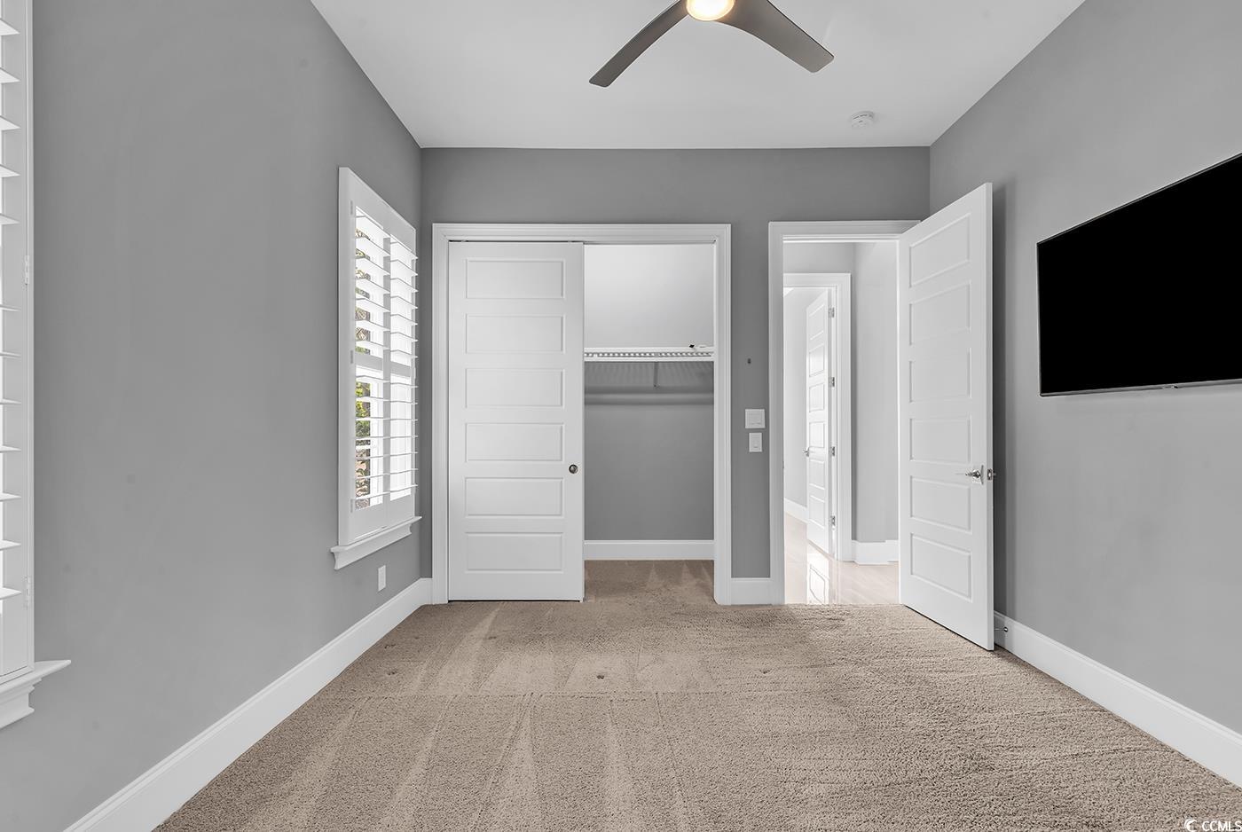 5960 Bolsena Place Myrtle Beach, SC 29572 - Photo 21 of 40 Unfurnished bedroom with light carpet, a closet, and ceiling fan