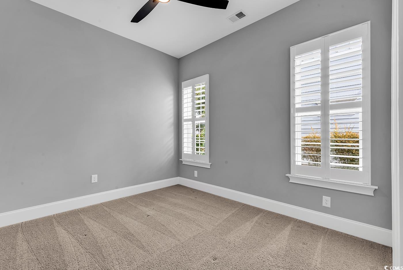 5960 Bolsena Place Myrtle Beach, SC 29572 - Photo 23 of 40 Carpeted spare room featuring ceiling fan