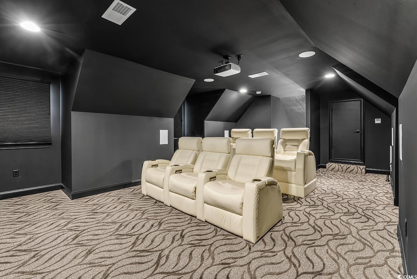 5960 Bolsena Place Myrtle Beach, SC 29572 - Photo 27 of 40 Home theater with lofted ceiling and light colored carpet