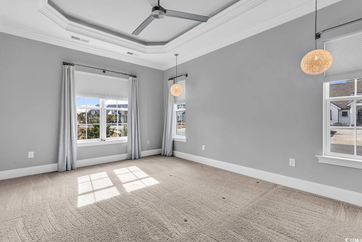 5960 Bolsena Place Myrtle Beach, SC 29572 - Photo 29 of 40 Carpeted spare room featuring ornamental molding, a raised ceiling, and ceiling fan