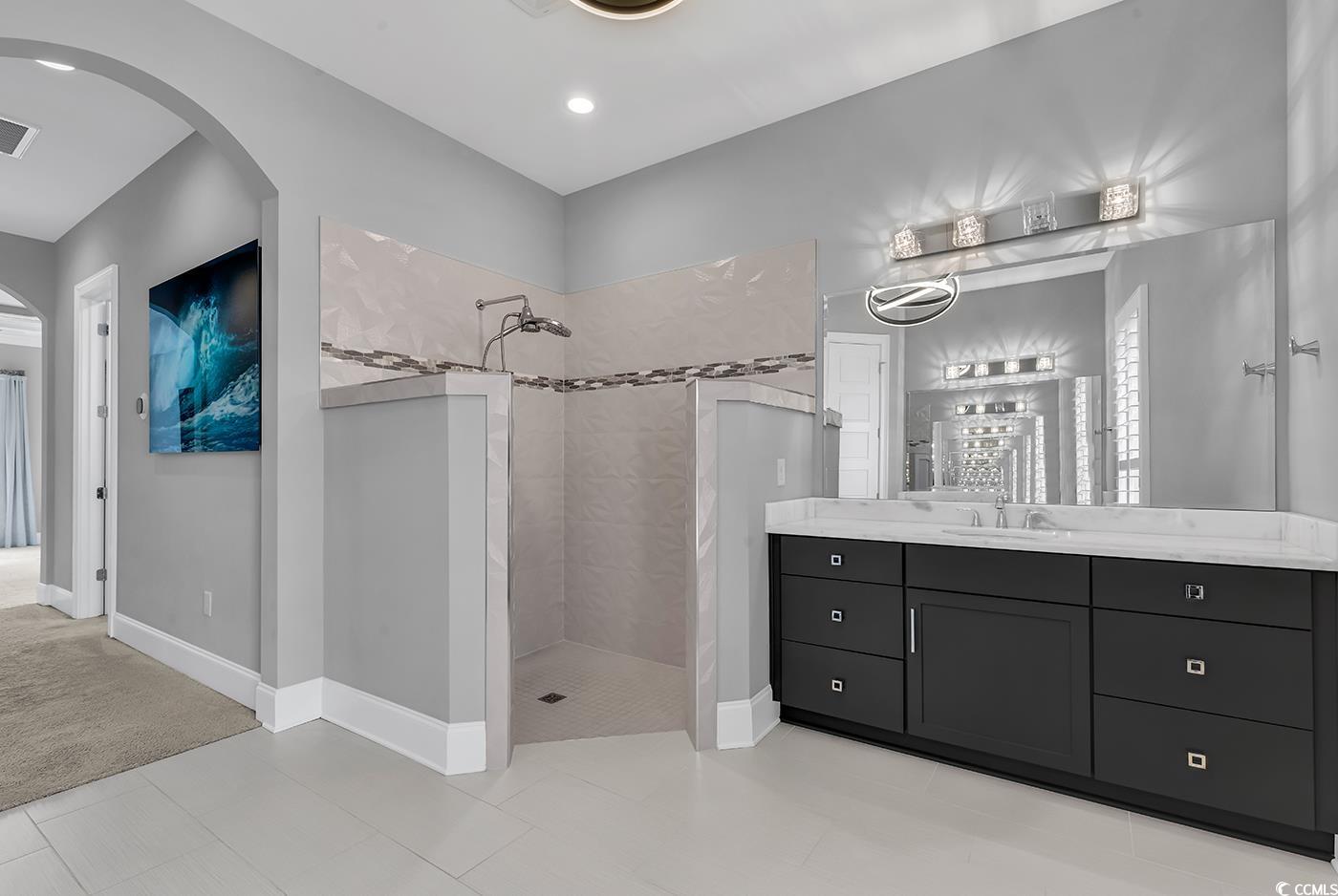 5960 Bolsena Place Myrtle Beach, SC 29572 - Photo 30 of 40 Bathroom featuring vanity and tiled shower