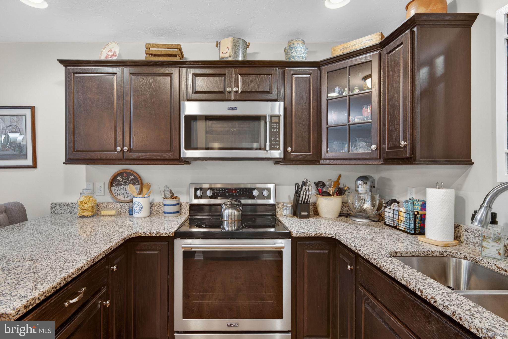 1332 Pleasant View Drive, Unit 75 Spring Grove, PA 17362 - Photo 14 of 26 a kitchen with stainless steel appliances granite countertop a sink stove and microwave
