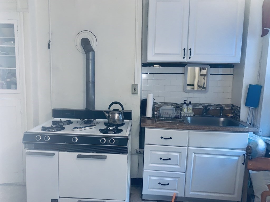 144-144A Salem Street Boston, MA 02113 - Photo 20 of 31 a kitchen with cabinets appliances and a counter space