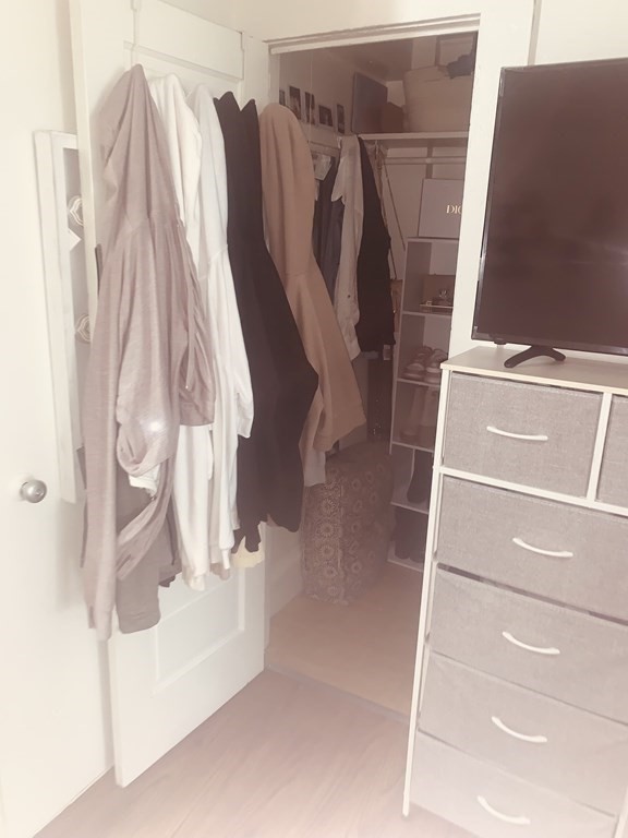 144-144A Salem Street Boston, MA 02113 - Photo 23 of 31 a view of walk in closet with clothes