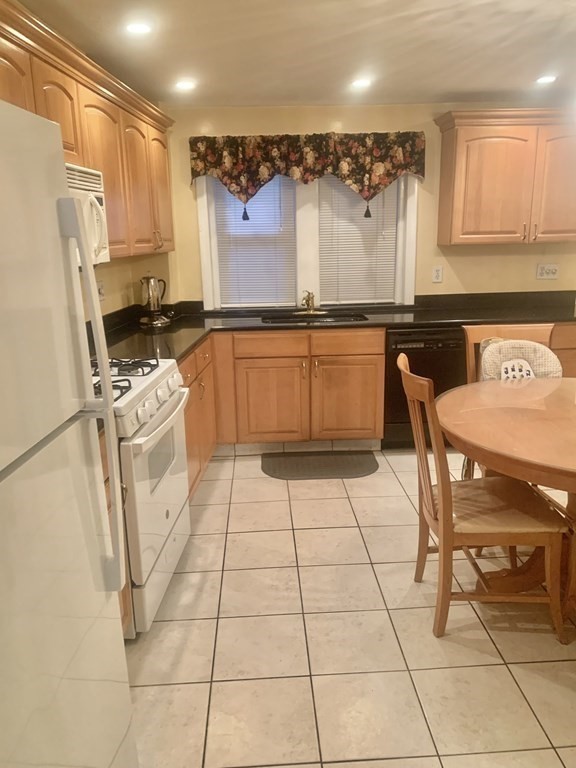 144-144A Salem Street Boston, MA 02113 - Photo 3 of 31 a kitchen with a sink a refrigerator and a stove
