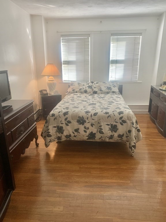 144-144A Salem Street Boston, MA 02113 - Photo 8 of 31 a bedroom with a bed and a window