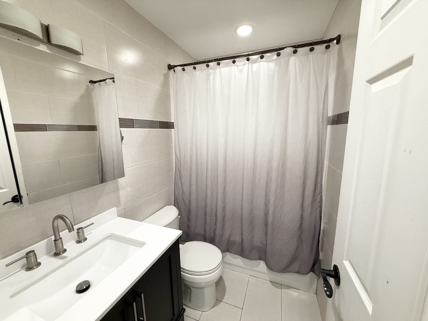 27W210 Providence Lane Winfield, IL 60190 - Photo 8 of 12 a bathroom with a sink a toilet and shower curtain