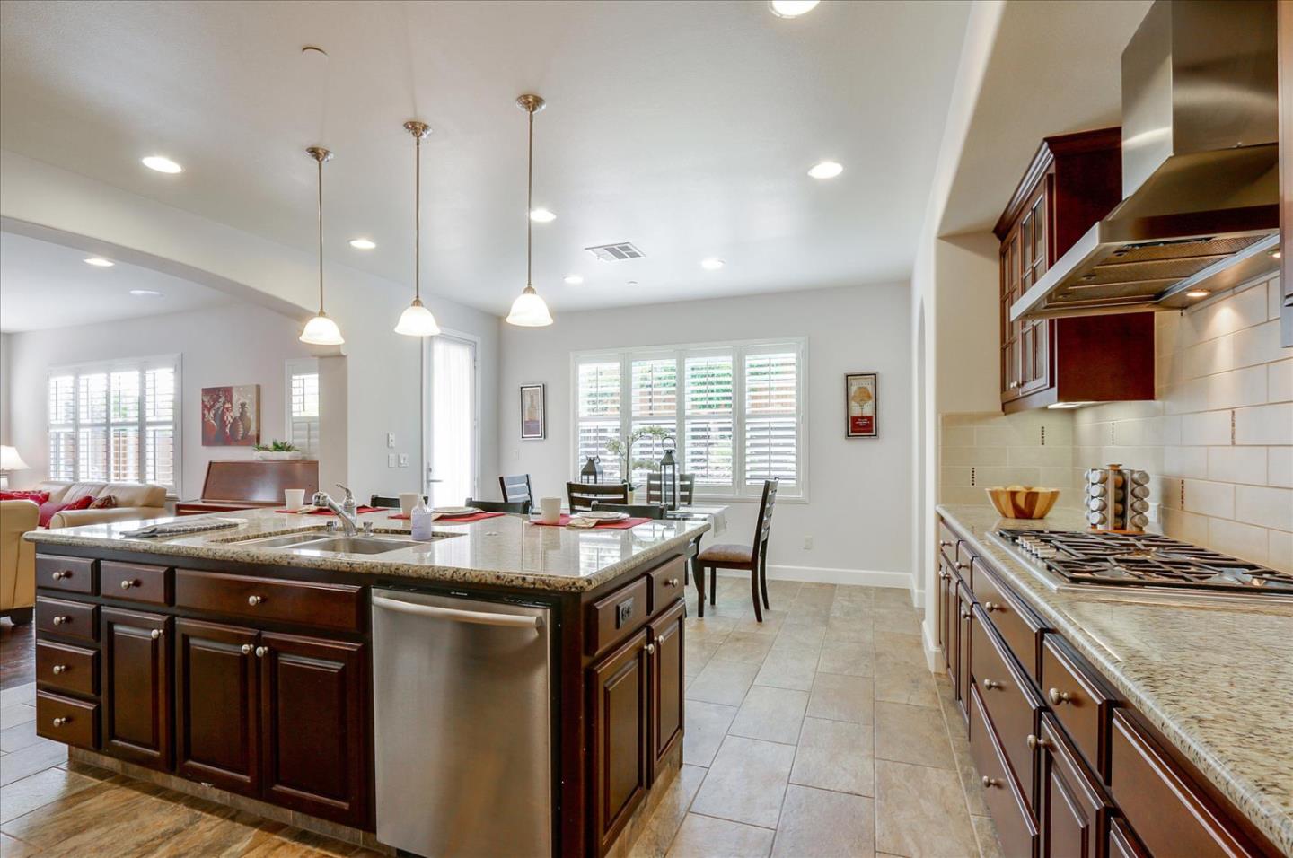 2333 Poppyview Avenue San Ramon, CA 94582 - Photo 13 of 65 a kitchen with stainless steel appliances granite countertop a sink a stove and a wooden floors