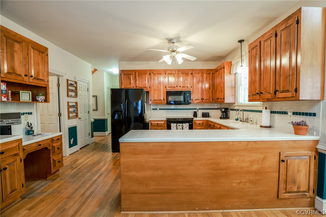 8606 Old Brompton Road Chesterfield, VA 23832 - Photo 11 of 36 a kitchen with stainless steel appliances granite countertop a refrigerator a sink dishwasher a stove with wooden cabinets and floor