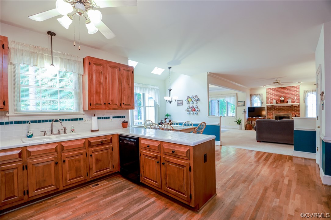 8606 Old Brompton Road Chesterfield, VA 23832 - Photo 12 of 36 a kitchen with a sink dishwasher cabinets and wooden floor