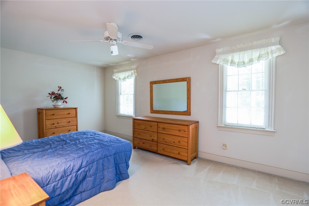 8606 Old Brompton Road Chesterfield, VA 23832 - Photo 20 of 36 a bedroom with a bed and a chandelier