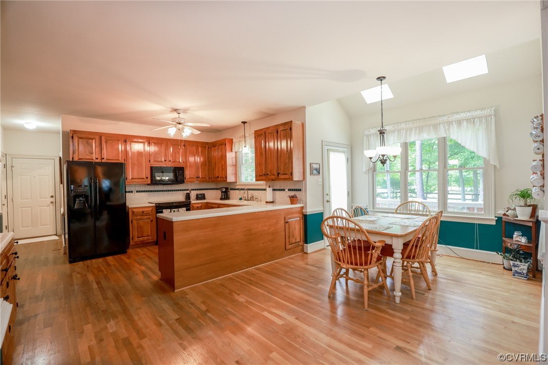 8606 Old Brompton Road Chesterfield, VA 23832 - Photo 10 of 36 a kitchen with a dining table chairs refrigerator and cabinets