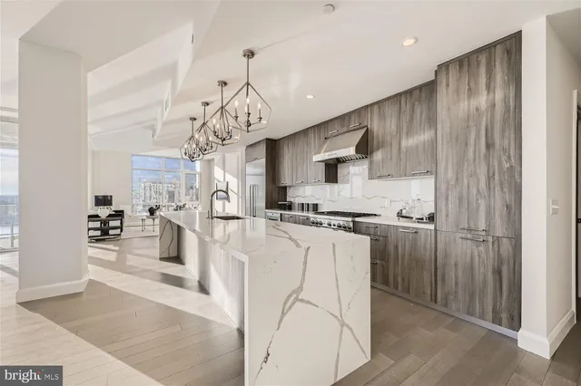 a view of a kitchen with granite countertop stainless steel appliances and wooden floor