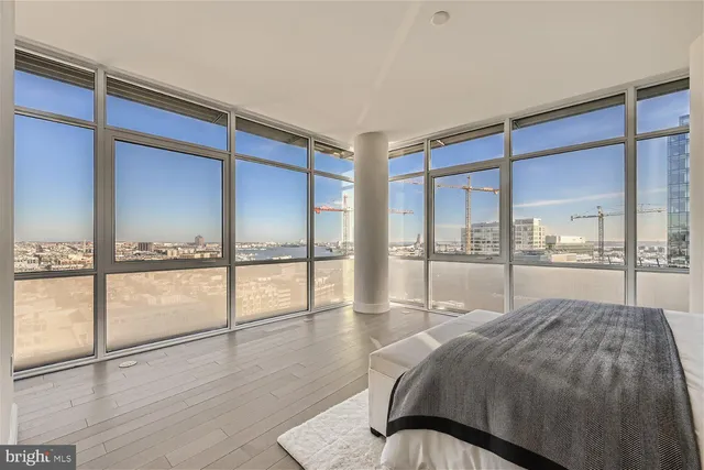 a bedroom with a bed and a large window