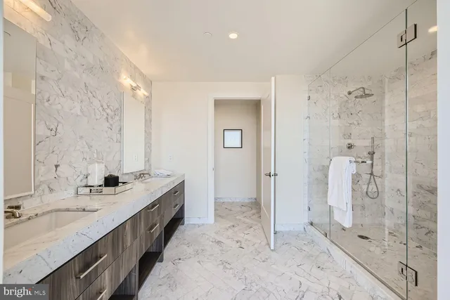 a bathroom with a double vanity sink and a mirror
