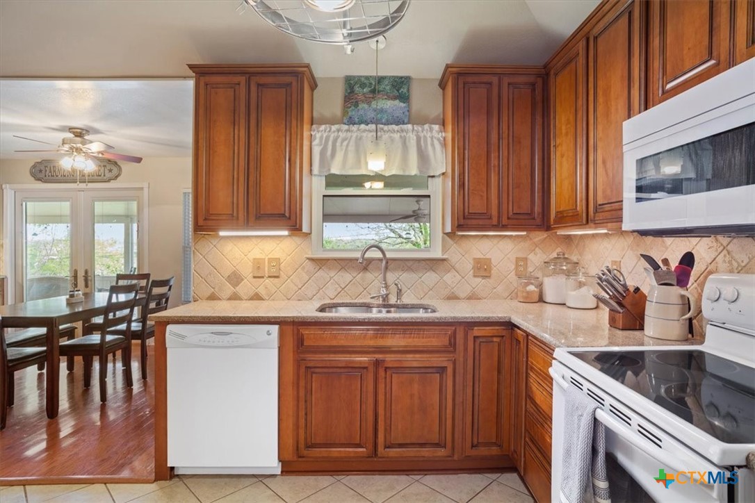 5943 Gavin Ridge Road Belton, TX 76513 - Photo 11 of 28 Tile backsplash and under cabinet lighting.