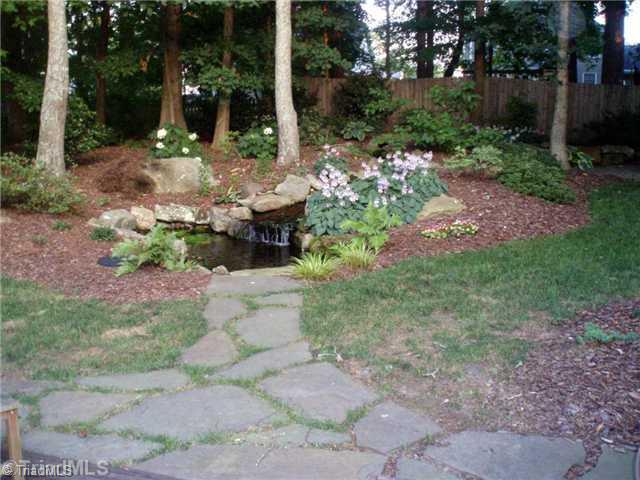 3306 Timberwolf Avenue High Point, NC 27265 - Photo 4 of 16 Landscaping. Beautiful water feature with waterfall & koi pond