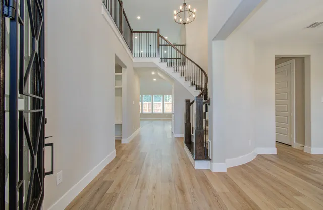a view of an entryway with wooden floor and door