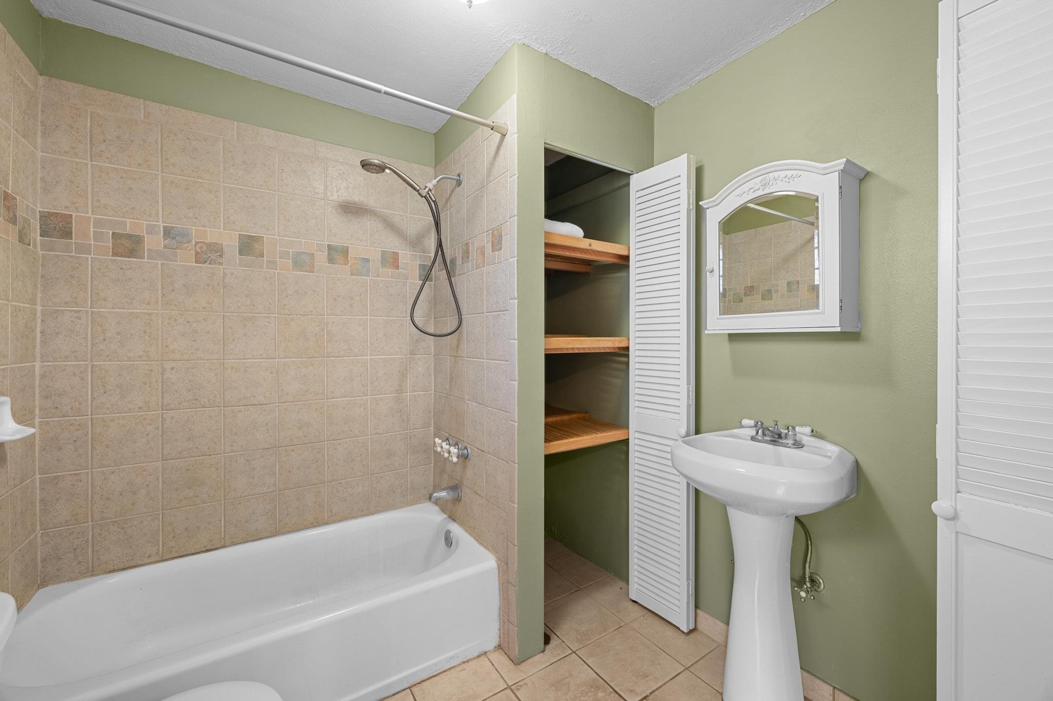 815 Kuulei Street Haiku, HI 96708 - Photo 13 of 26 a bathroom with a sink a toilet and shower