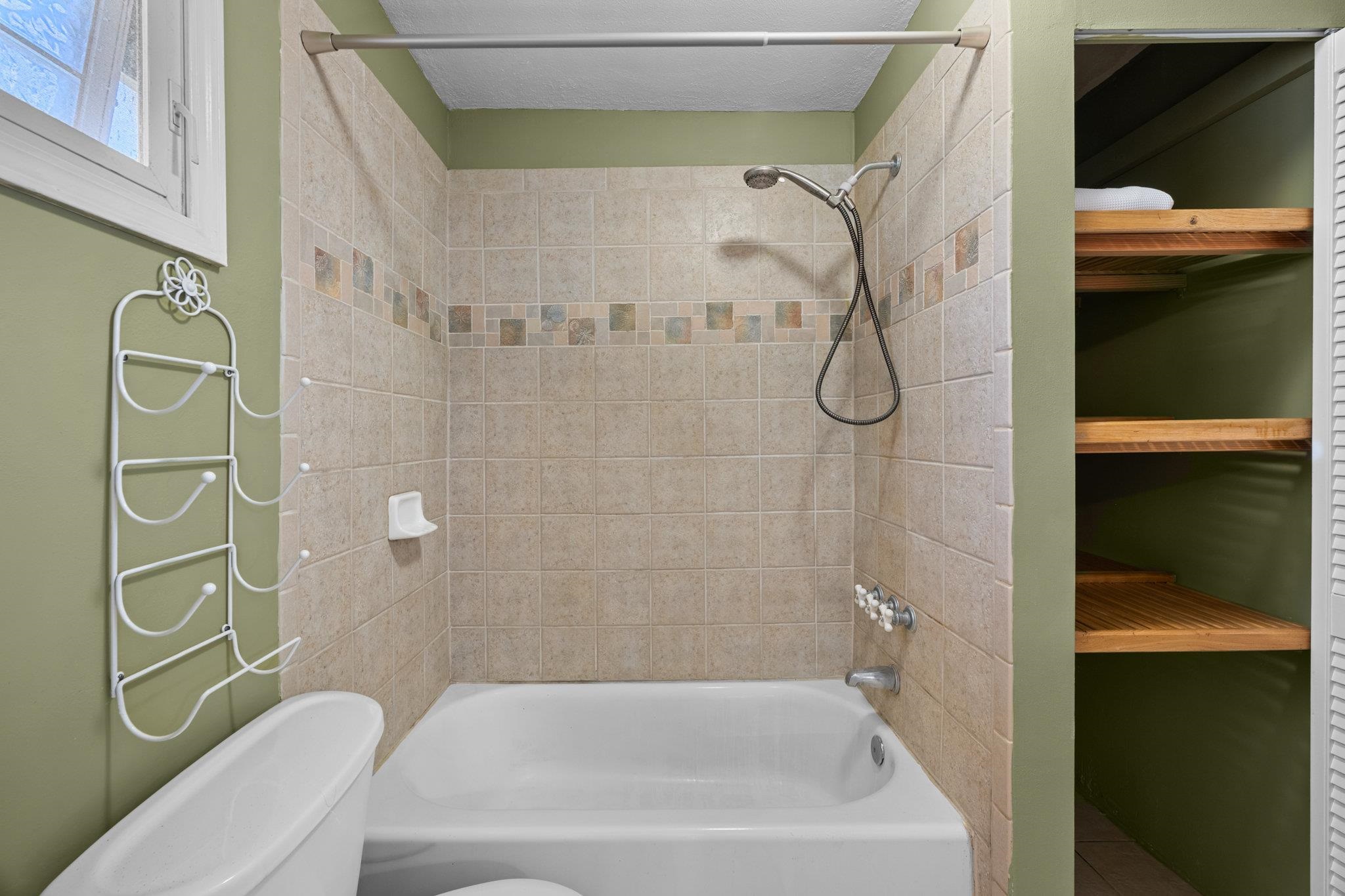 815 Kuulei Street Haiku, HI 96708 - Photo 14 of 26 a bathroom with a bath tub and shower