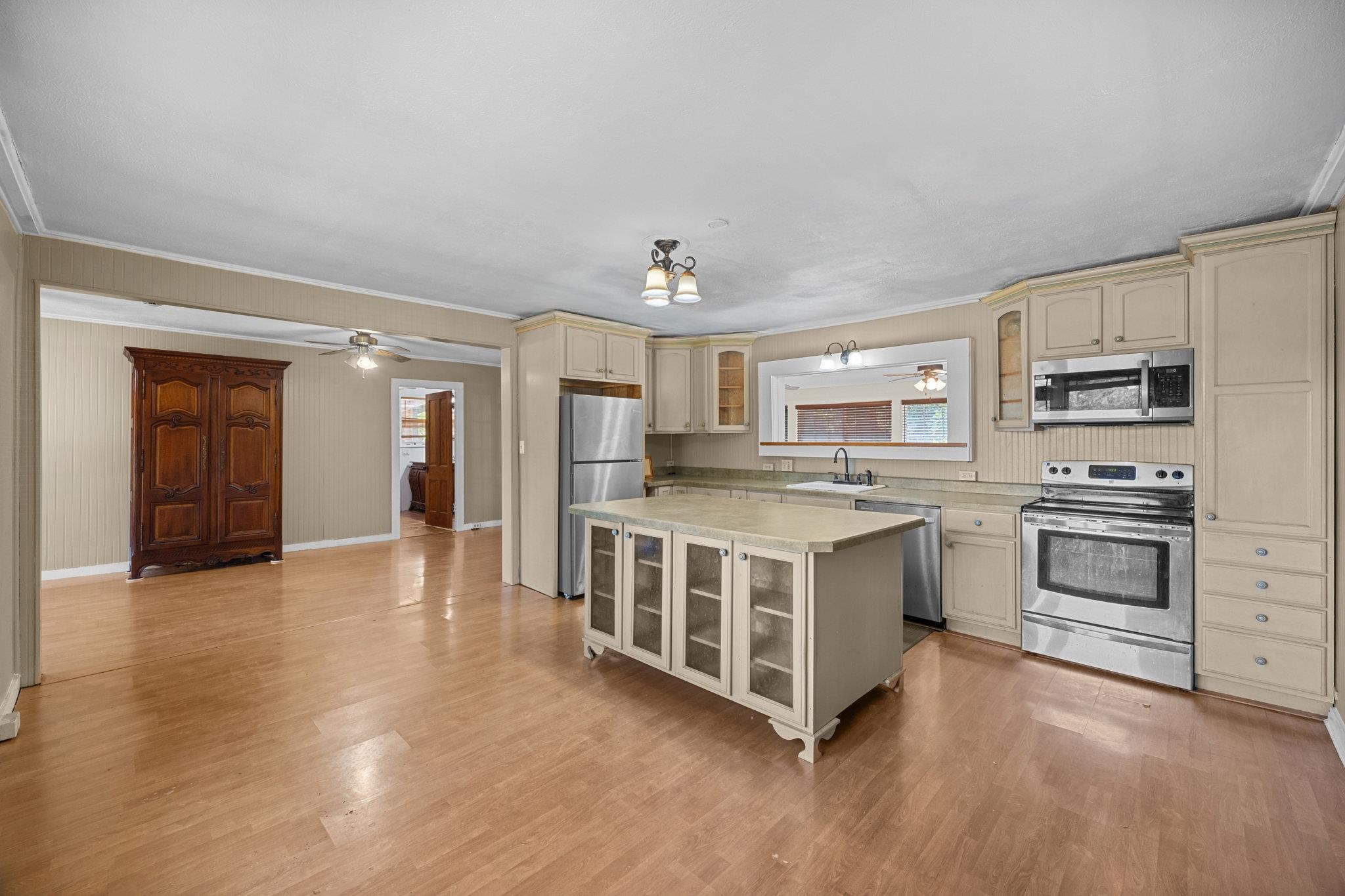 815 Kuulei Street Haiku, HI 96708 - Photo 2 of 26 a kitchen with stainless steel appliances a white stove top oven and a refrigerator