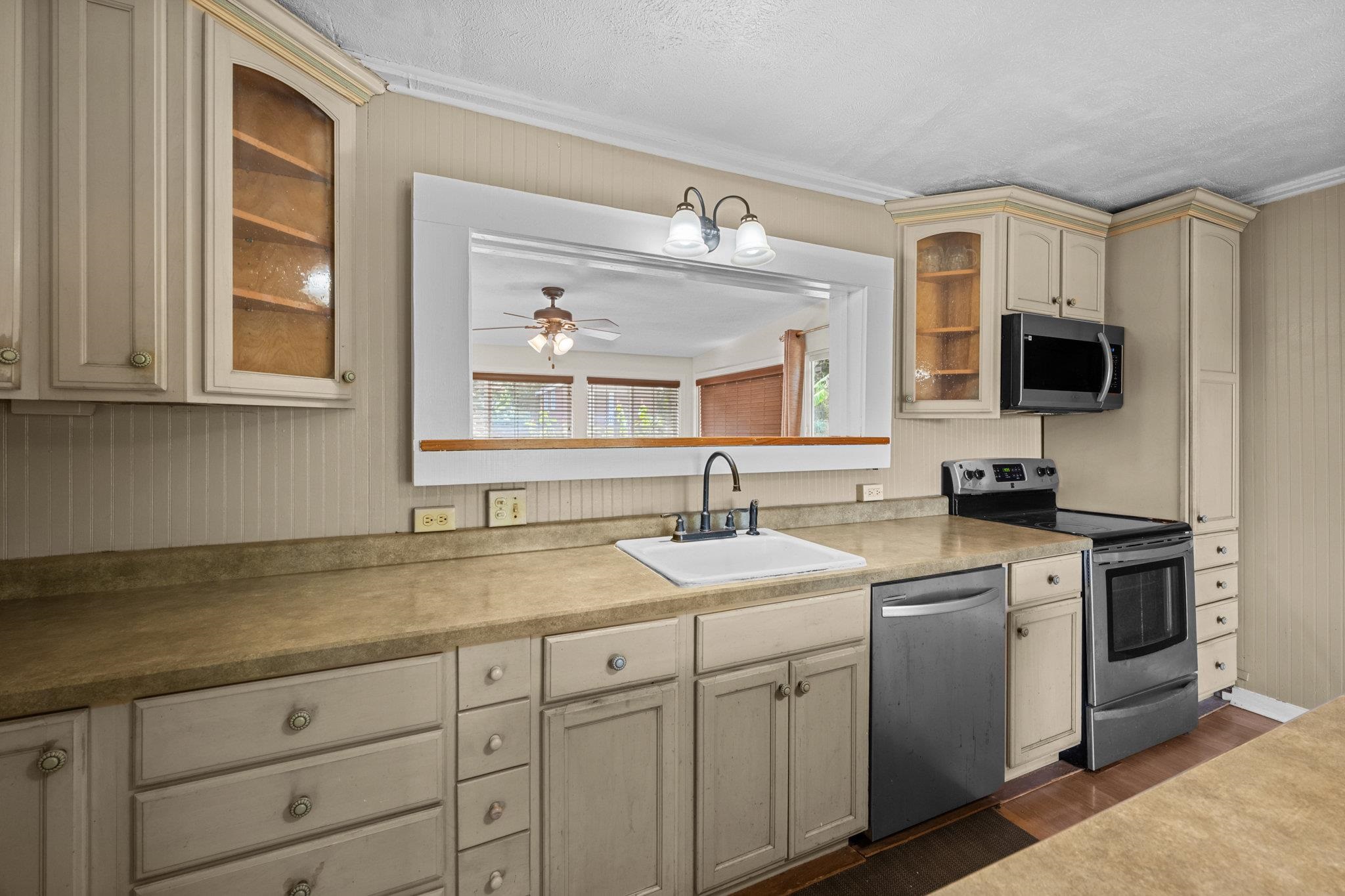 815 Kuulei Street Haiku, HI 96708 - Photo 4 of 26 a kitchen with sink stove and microwave