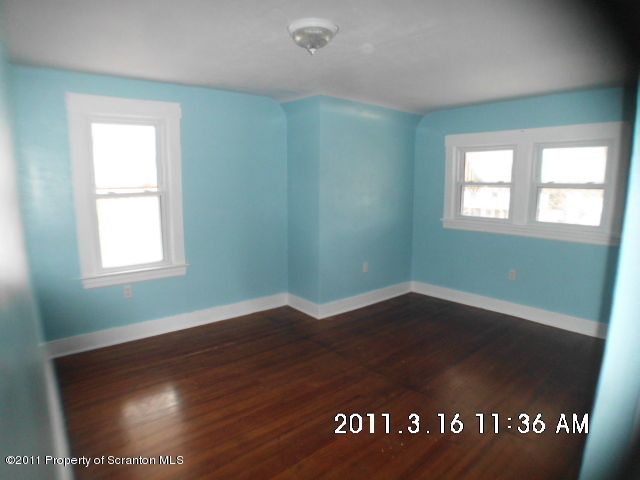 213 Bennett Street Exeter, PA 18643 - Photo 8 of 10 an empty room with wooden floor and windows