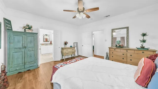 a bedroom with a bed and a dresser