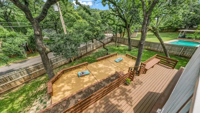 a view of a balcony with wooden floor and outdoor space