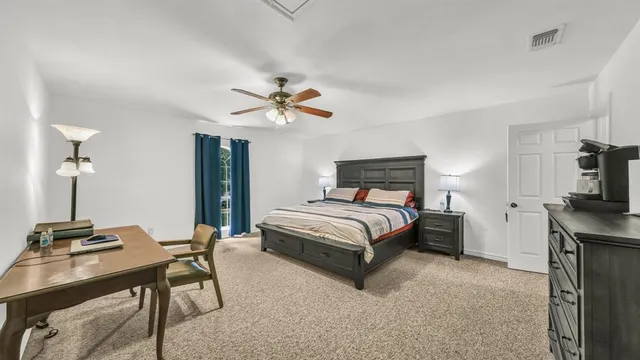 a bedroom with a bed and a table in it