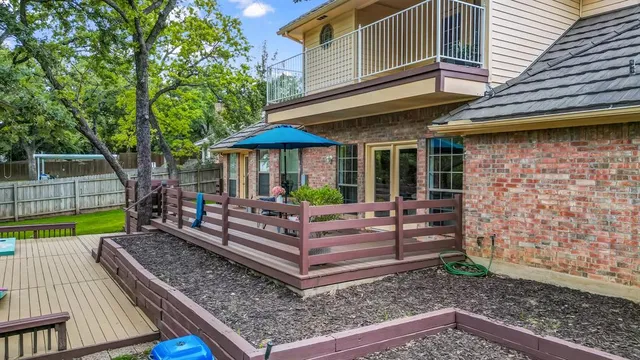 a view of a wooden chairs and table in the patio