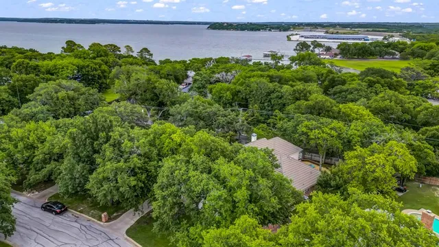 a backyard of a house with lots of green space and lake view