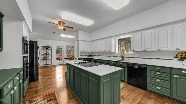 a kitchen with a stove a sink and a refrigerator