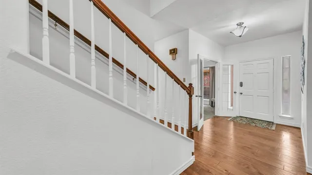 a view of entryway with wooden floor and stairs