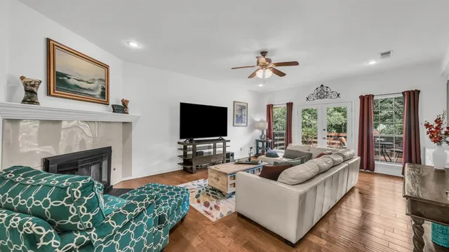 a living room with furniture a fireplace and a flat screen tv