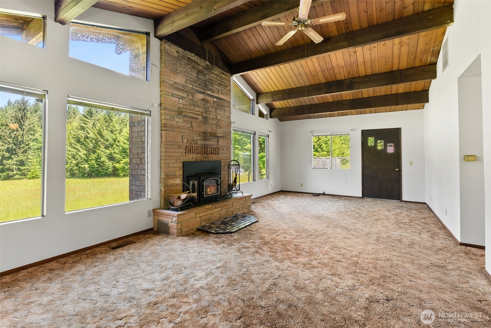 155 Bonell Road Randle, WA 98377 - Photo 6 of 38 a view of an empty room with a window and fire place