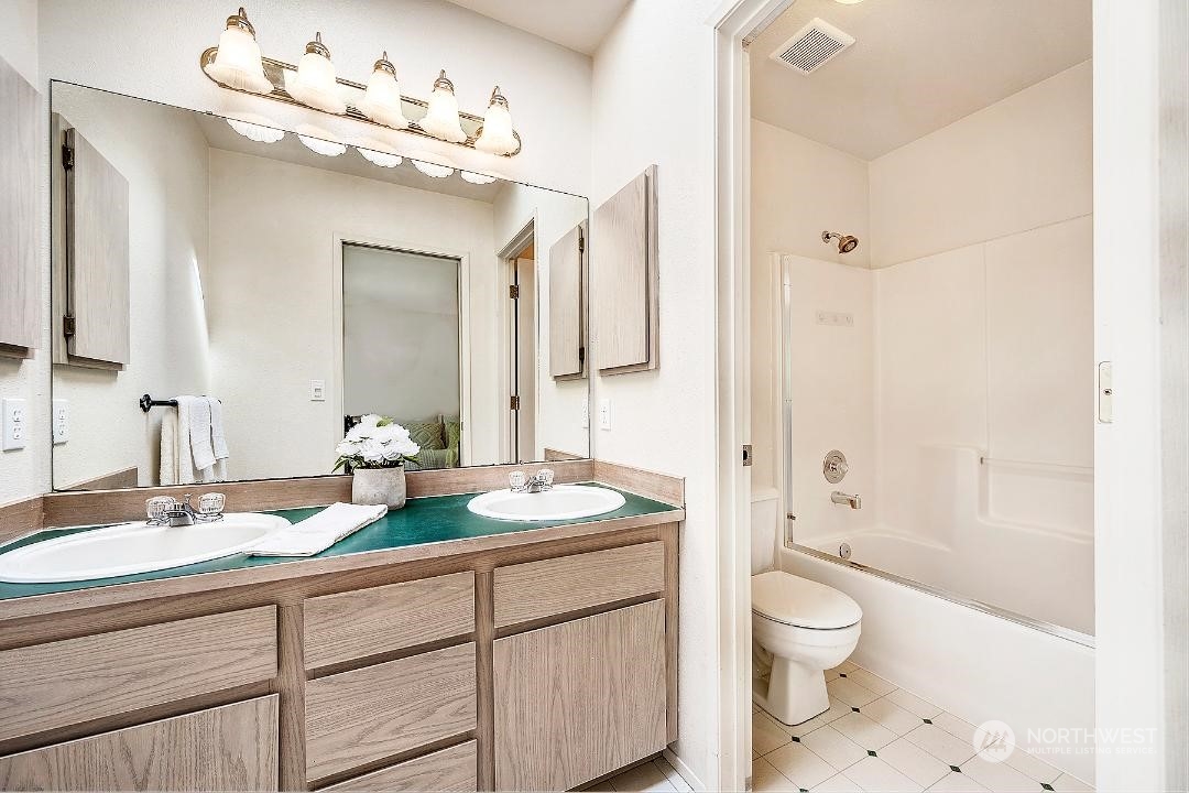 1421 231st Street Southeast Bothell, WA 98021 - Photo 11 of 21 a bathroom with a sink a toilet and a large mirror