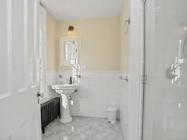 a bathroom with a sink a toilet and mirror