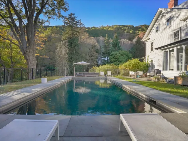 a view of a swimming pool with a yard