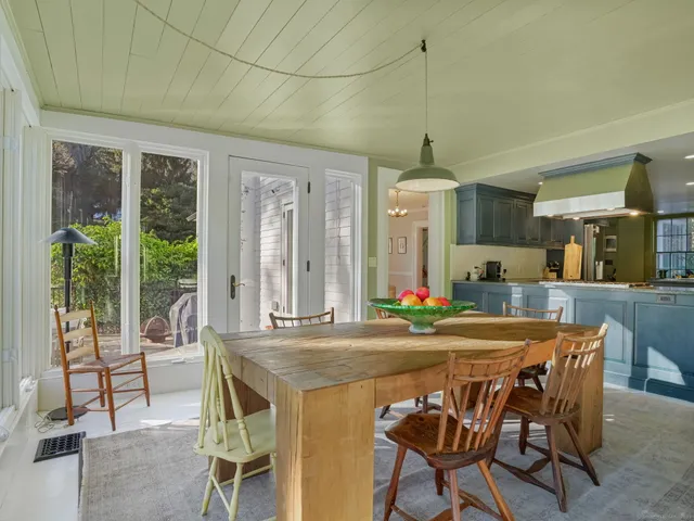 a dining room with furniture and window