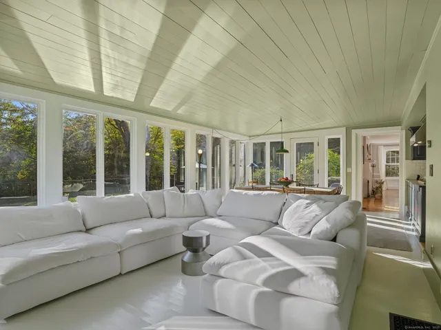 a living room with furniture and large windows