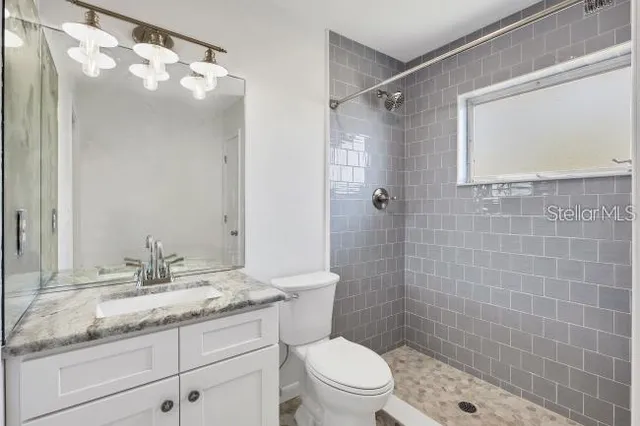 a view of a living room and chandelier fan