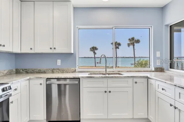 a kitchen with stainless steel appliances a refrigerator and a stove top oven