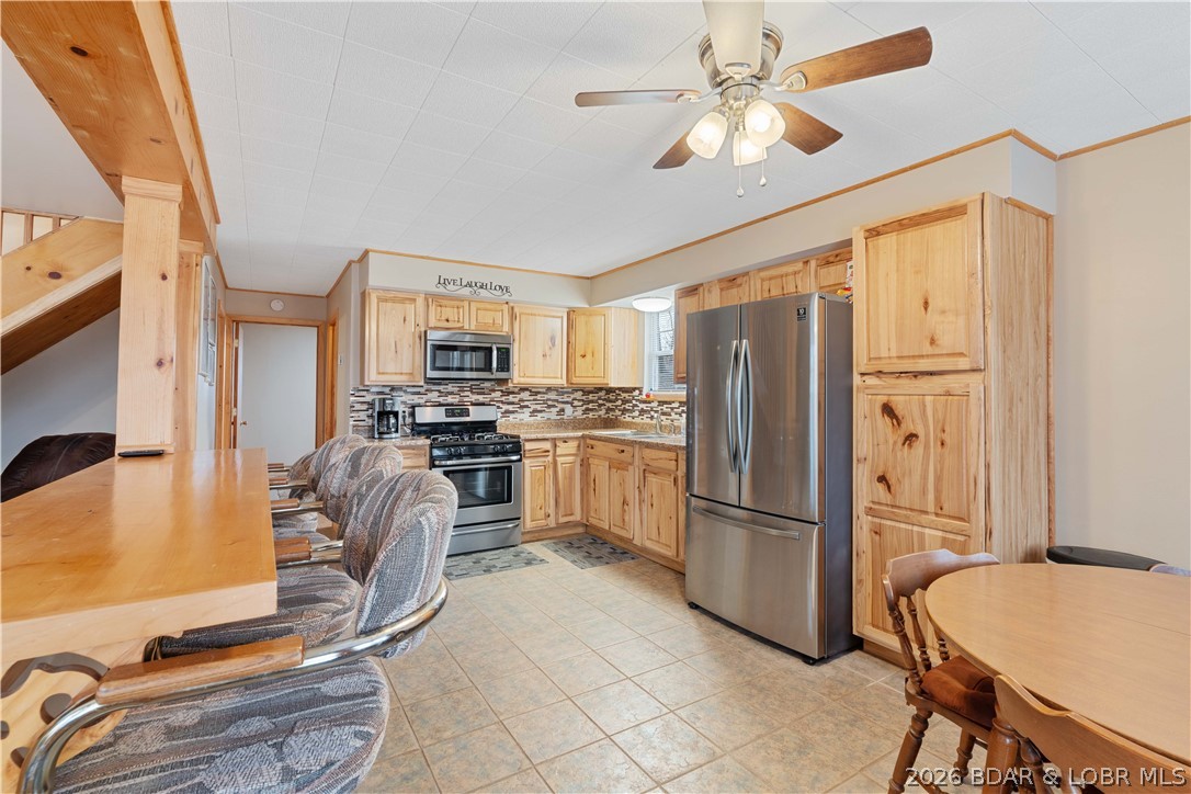 31048 Broken Circle Road Stover, MO 65078 - Photo 11 of 59 Spacious kitchen provides an eat in bar overlookin