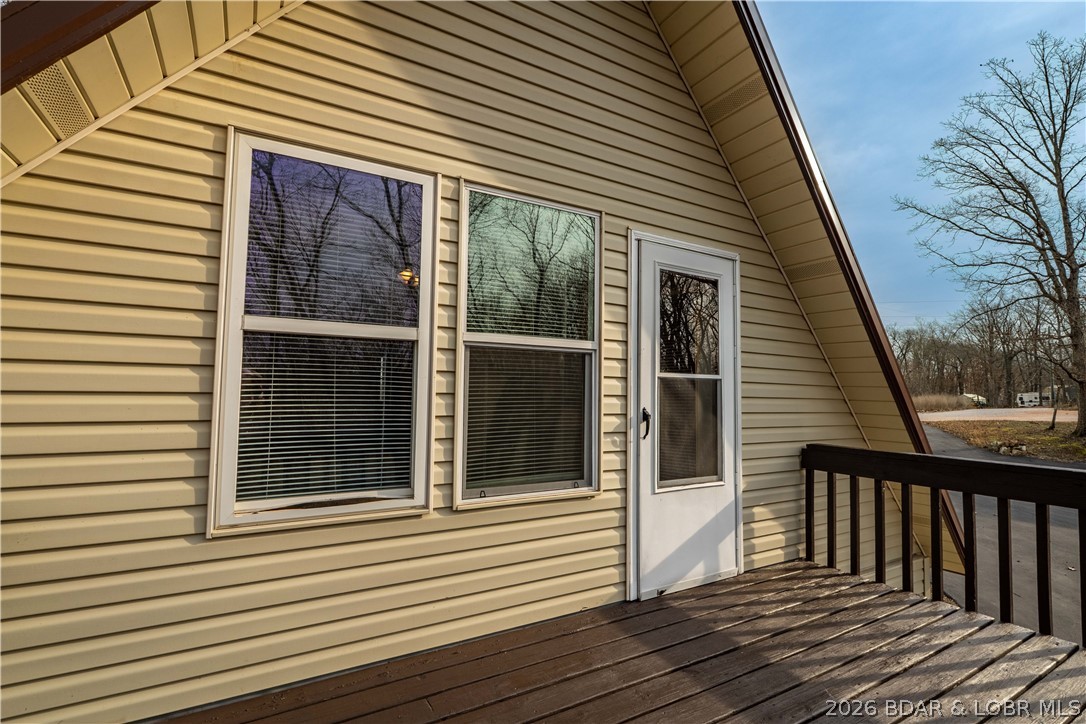 31048 Broken Circle Road Stover, MO 65078 - Photo 28 of 59 Located off upper level primary bedroom, this deck
