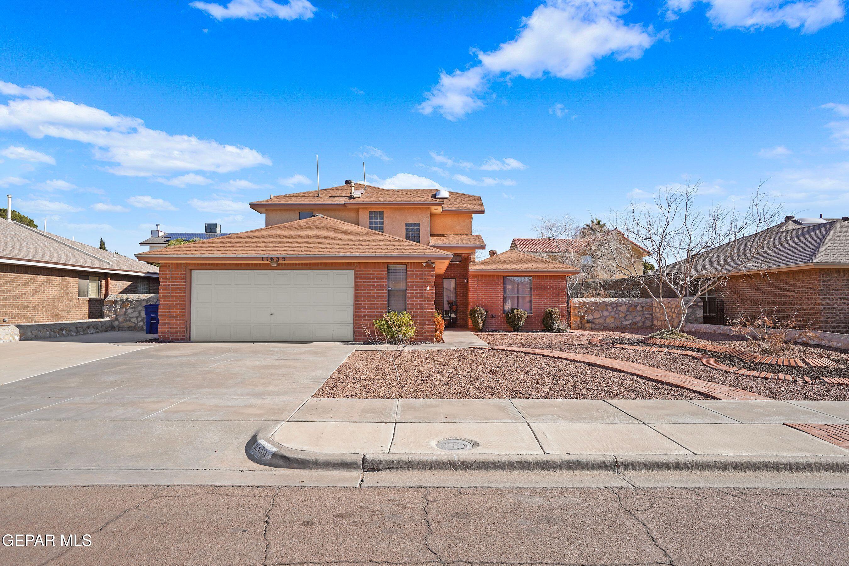 11635 Rufus Brijalba Drive El Paso, TX 79936 - Photo 1 of 32 a front view of a house with a yard