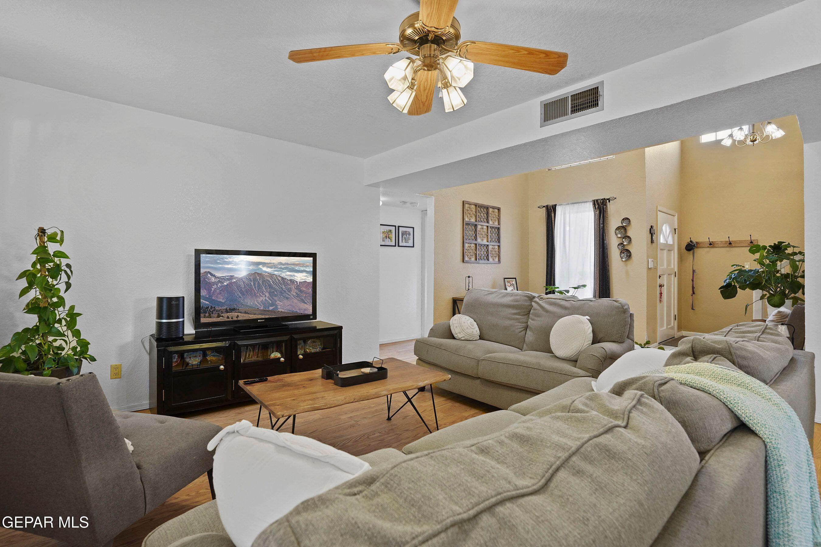 11635 Rufus Brijalba Drive El Paso, TX 79936 - Photo 9 of 32 a living room with furniture and a flat screen tv